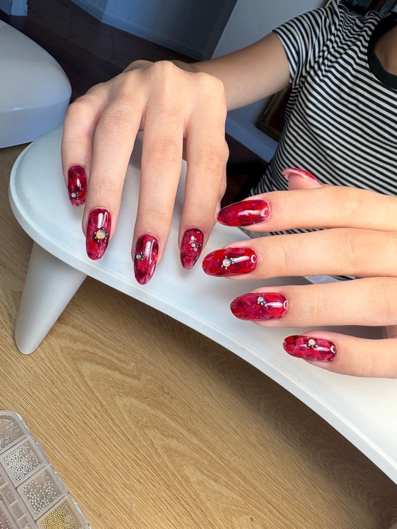Red marble nail extensions at Queen Bee Nails Rockingham WA