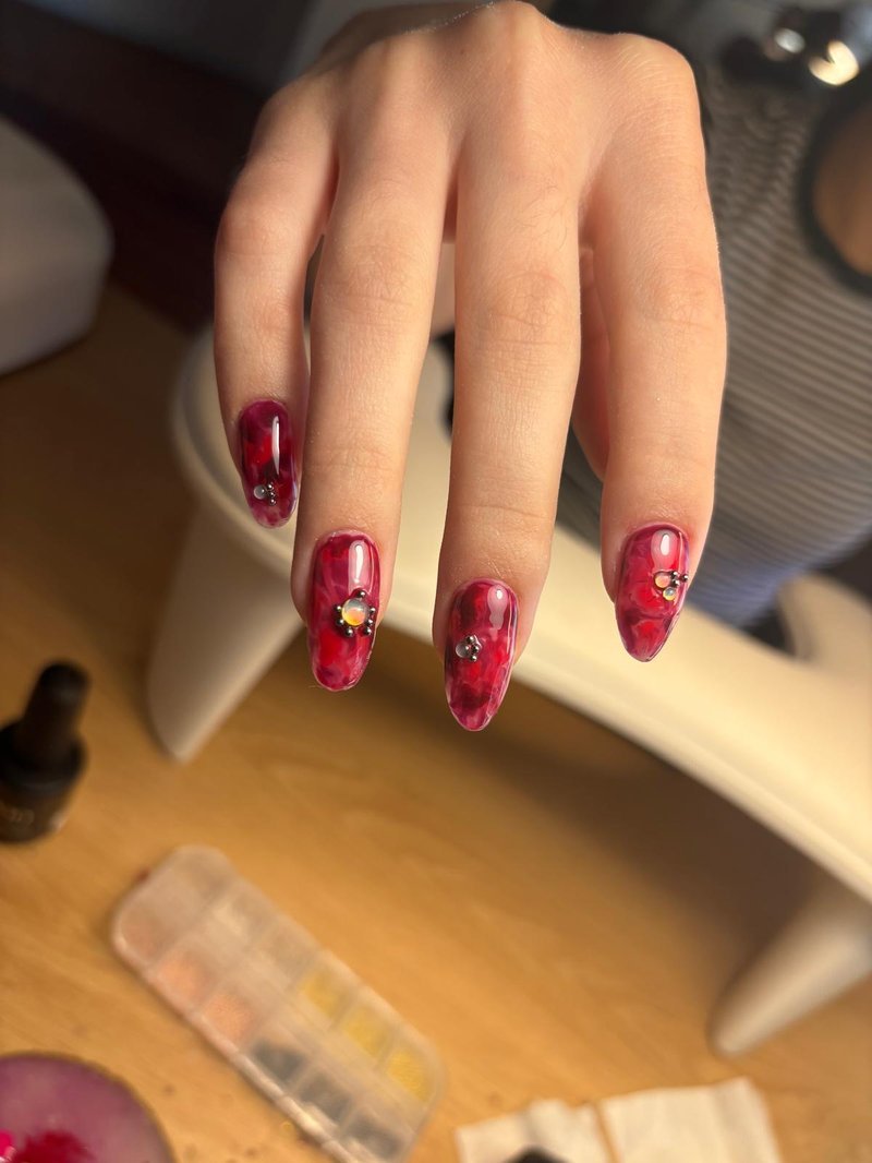 Red marble stiletto nail extensions at Queen Bee Nails Rockingham WA